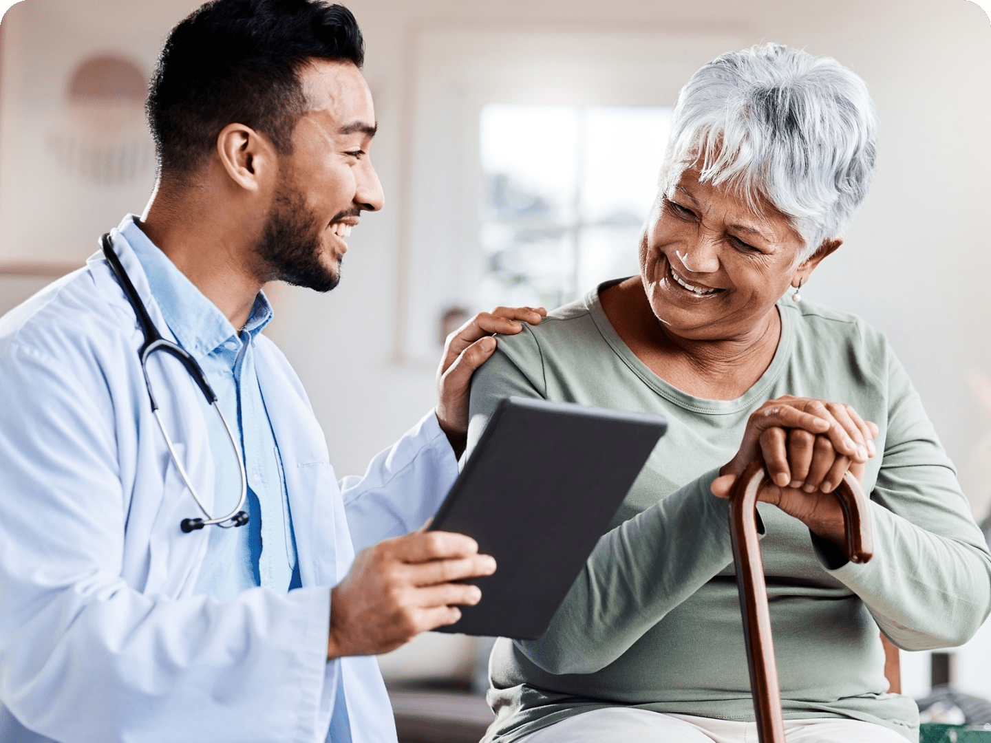 Doctor consulting with elderly patient, smiling warmly.